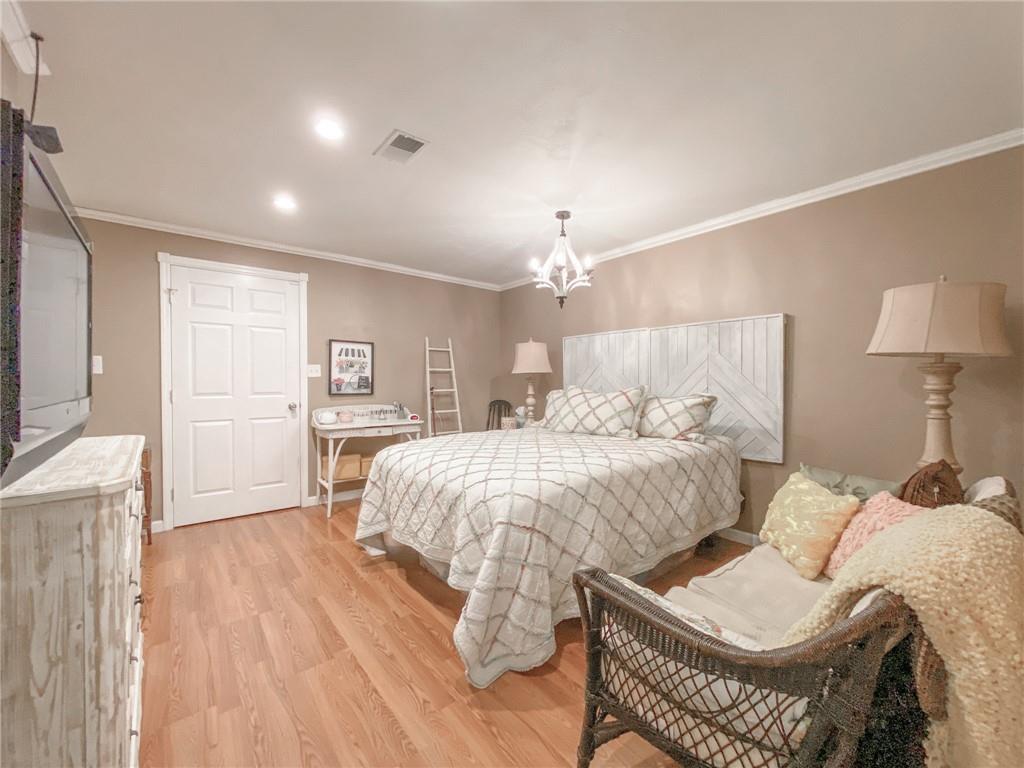 2022 Ridge Rd Extension Ambridge, PA 15003 - Photo 13 of 22 a spacious bedroom with a bed a chandelier and couch