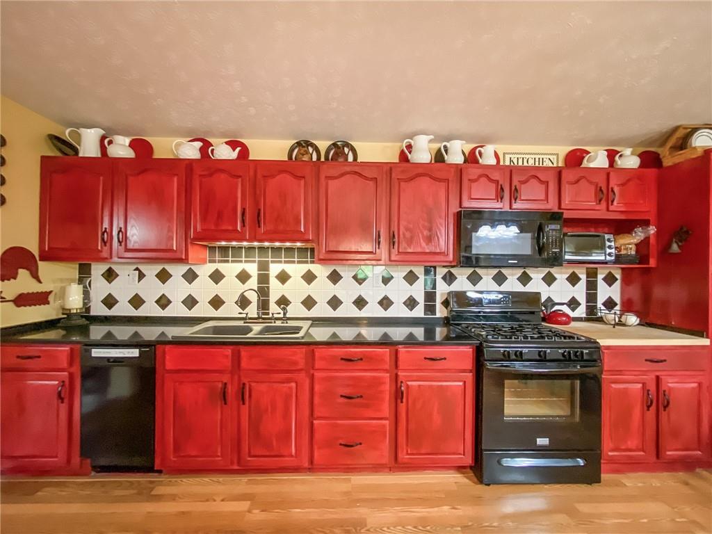 2022 Ridge Rd Extension Ambridge, PA 15003 - Photo 5 of 22 a kitchen with granite countertop a stove and cabinets