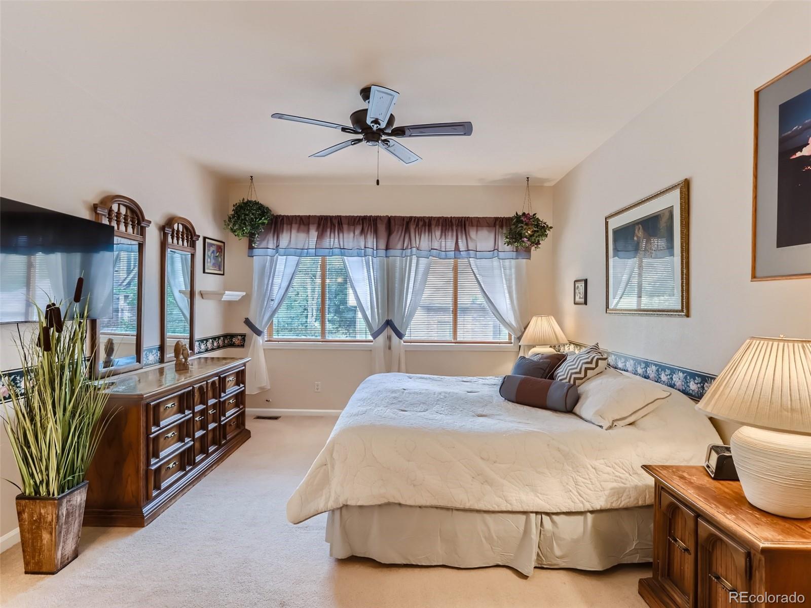 6370 Eagle Court Longmont, CO 80503 - Photo 13 of 39 a bedroom with a bed a chandelier and dresser