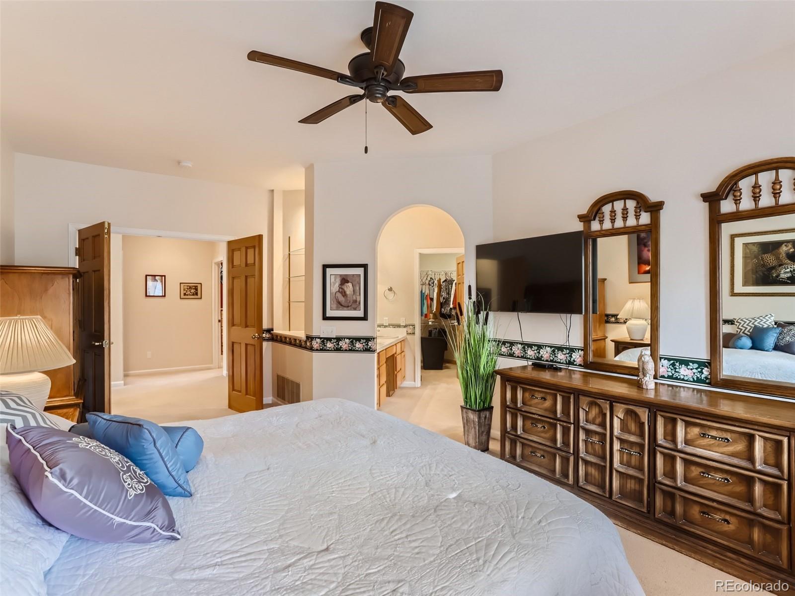6370 Eagle Court Longmont, CO 80503 - Photo 14 of 39 a bedroom with a bed a flat screen tv and a dresser