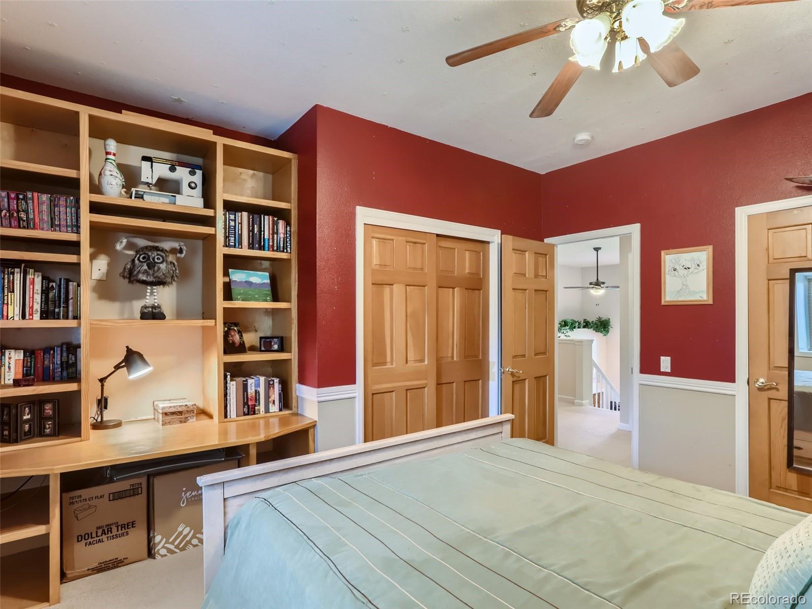 6370 Eagle Court Longmont, CO 80503 - Photo 18 of 39 a bedroom with furniture and a book shelf
