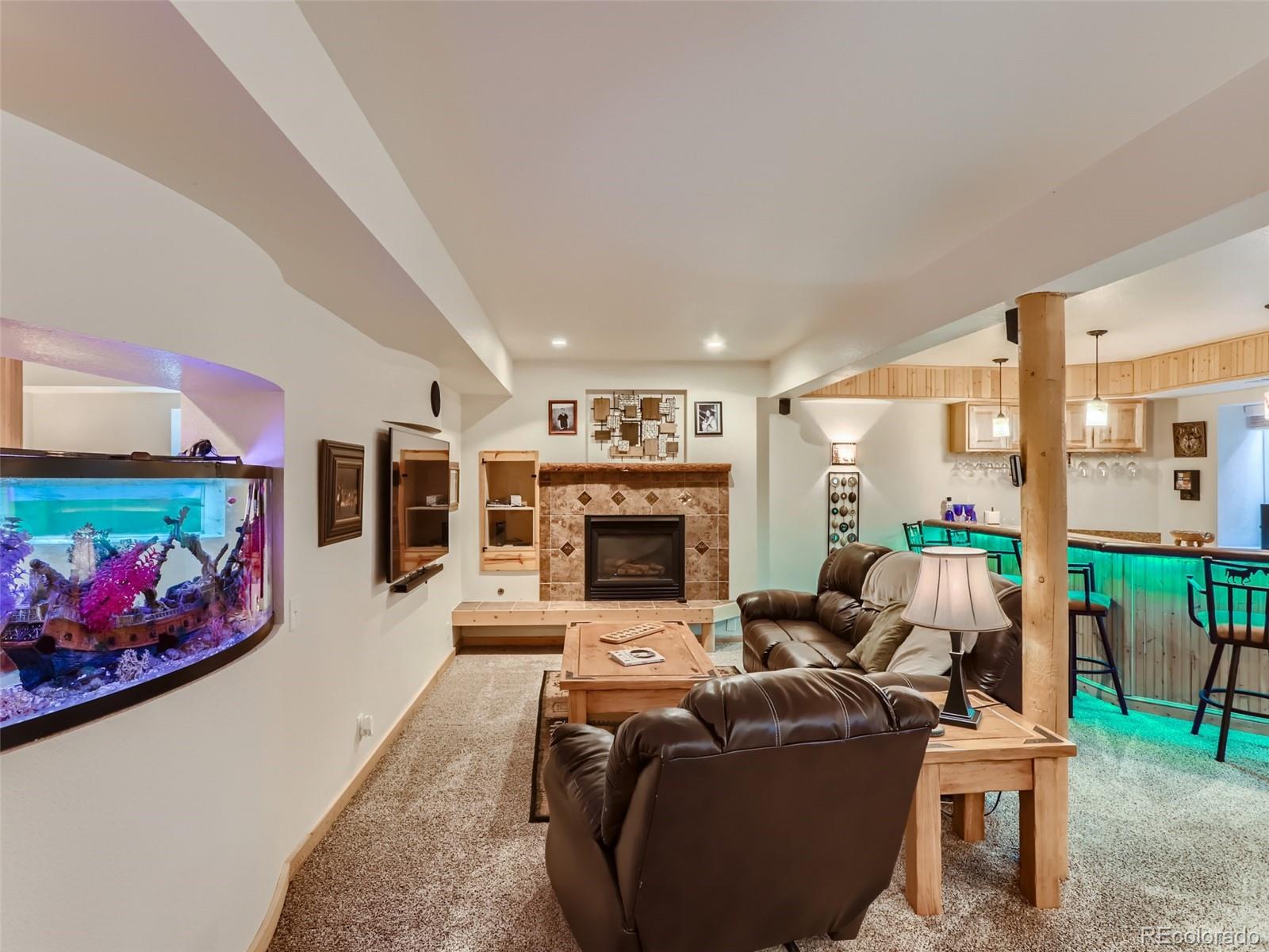 6370 Eagle Court Longmont, CO 80503 - Photo 23 of 39 a living room with furniture fireplace and flat screen tv