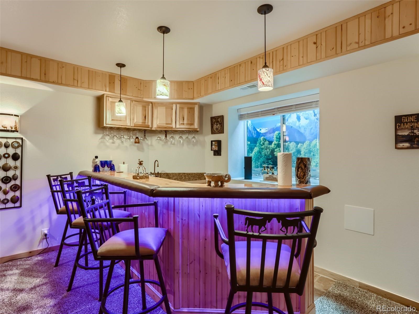 6370 Eagle Court Longmont, CO 80503 - Photo 26 of 39 a kitchen with a dining table chairs stainless steel appliances and cabinets