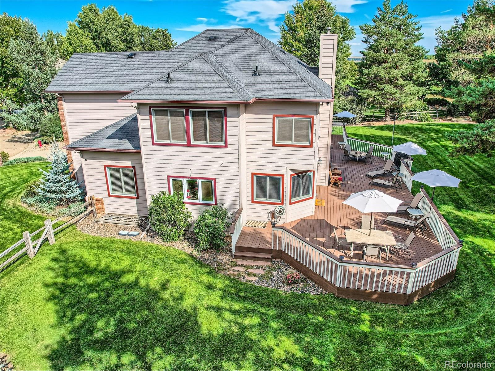 6370 Eagle Court Longmont, CO 80503 - Photo 27 of 39 a front view of a house with a garden and trees