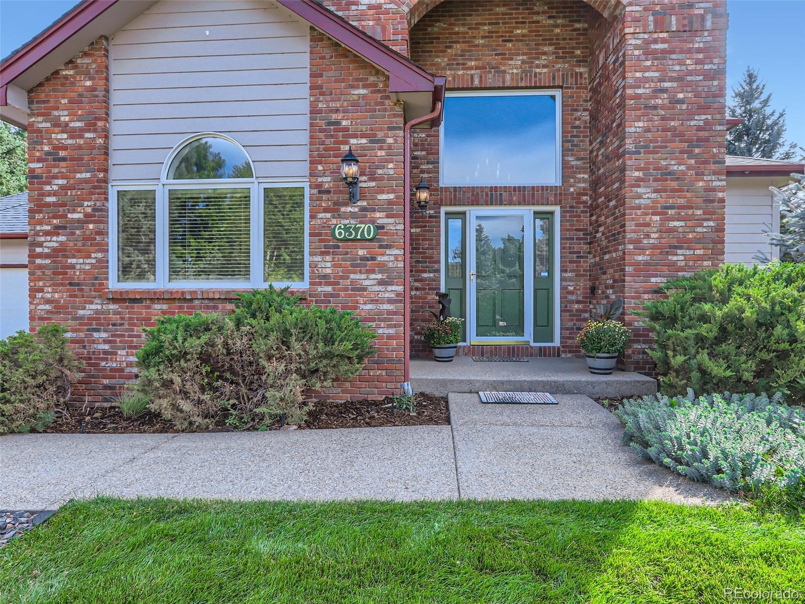 6370 Eagle Court Longmont, CO 80503 - Photo 3 of 39 a front view of a house with garden