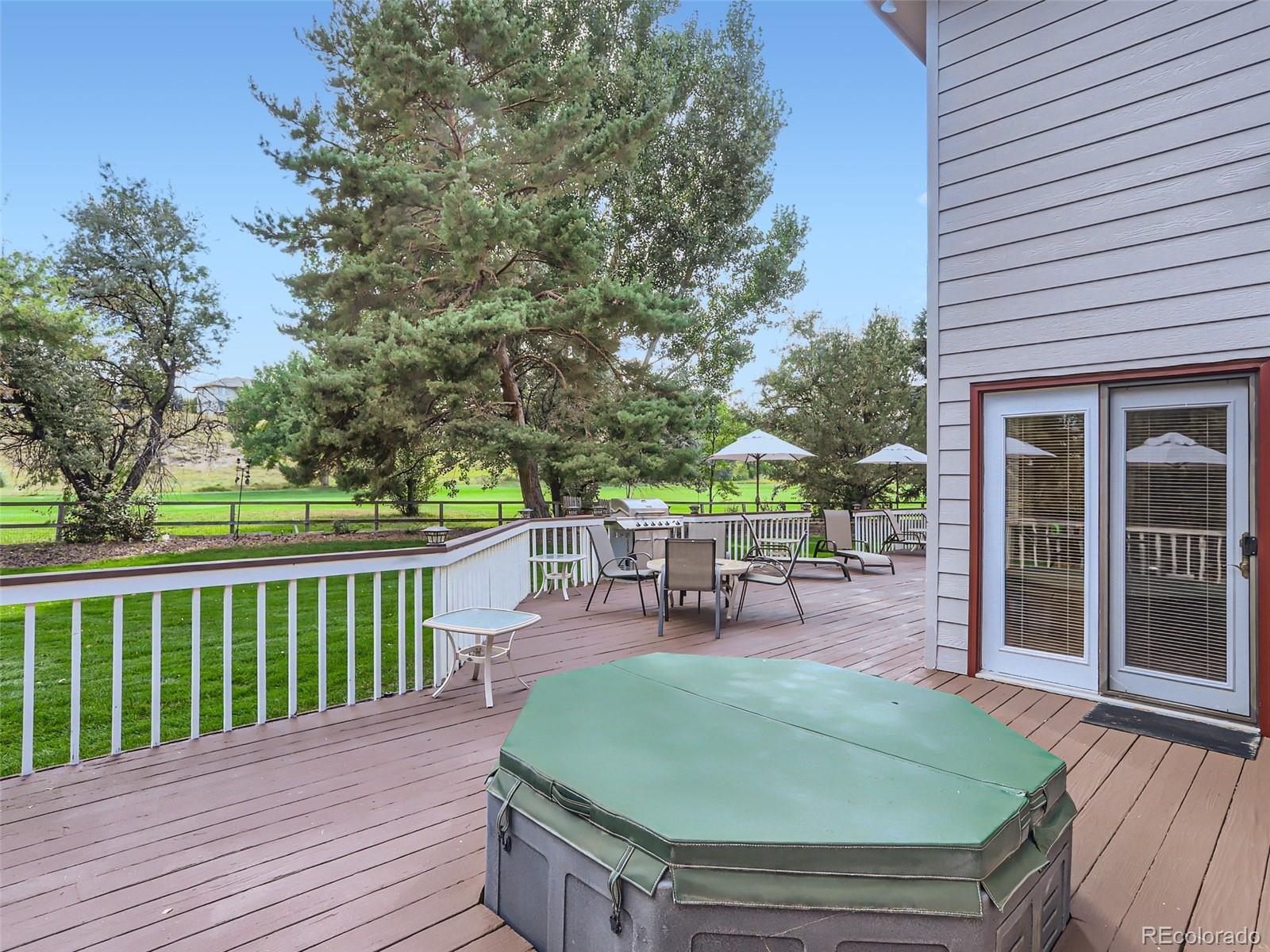 6370 Eagle Court Longmont, CO 80503 - Photo 31 of 39 a view of a chairs and table on the wooden deck