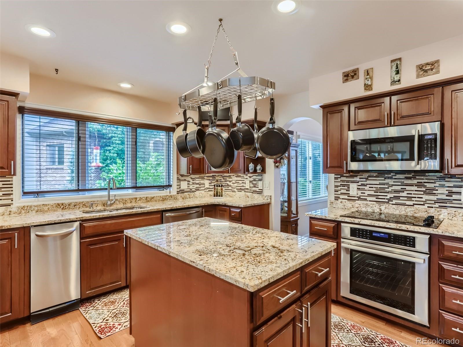 6370 Eagle Court Longmont, CO 80503 - Photo 8 of 39 a kitchen with stainless steel appliances granite countertop a stove and a sink
