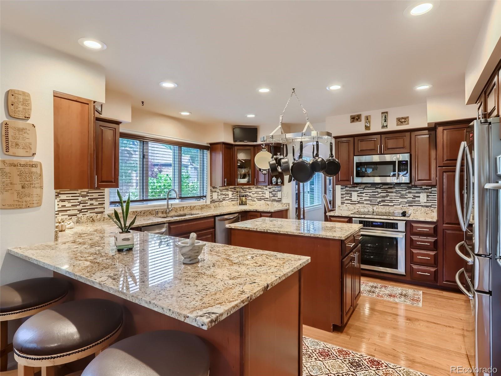 6370 Eagle Court Longmont, CO 80503 - Photo 9 of 39 a kitchen with stainless steel appliances granite countertop a sink refrigerator and cabinets