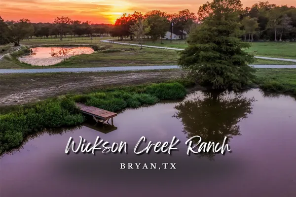 a view of a park that has a bench and a lake view