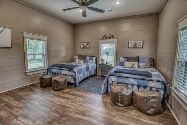 a bedroom with two beds and a window