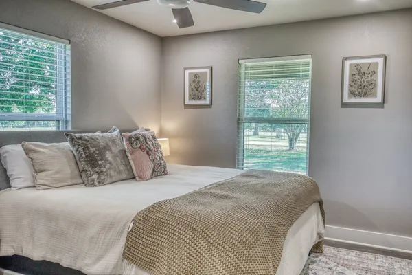 a bedroom with a large bed and a window