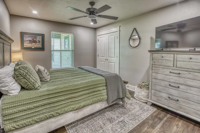 a bedroom with a bed and a flat screen tv