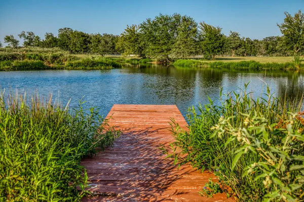 a view of a lake with a house in the background
