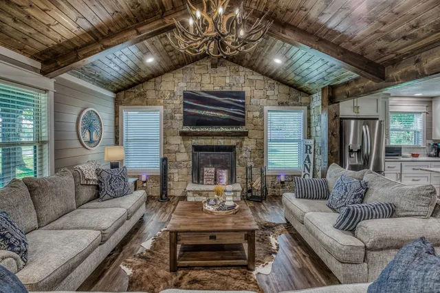 a living room with furniture a fireplace and a table