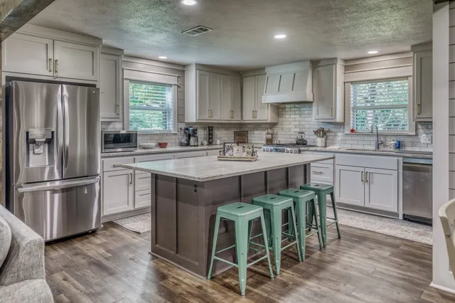 a kitchen with a sink appliances and cabinets