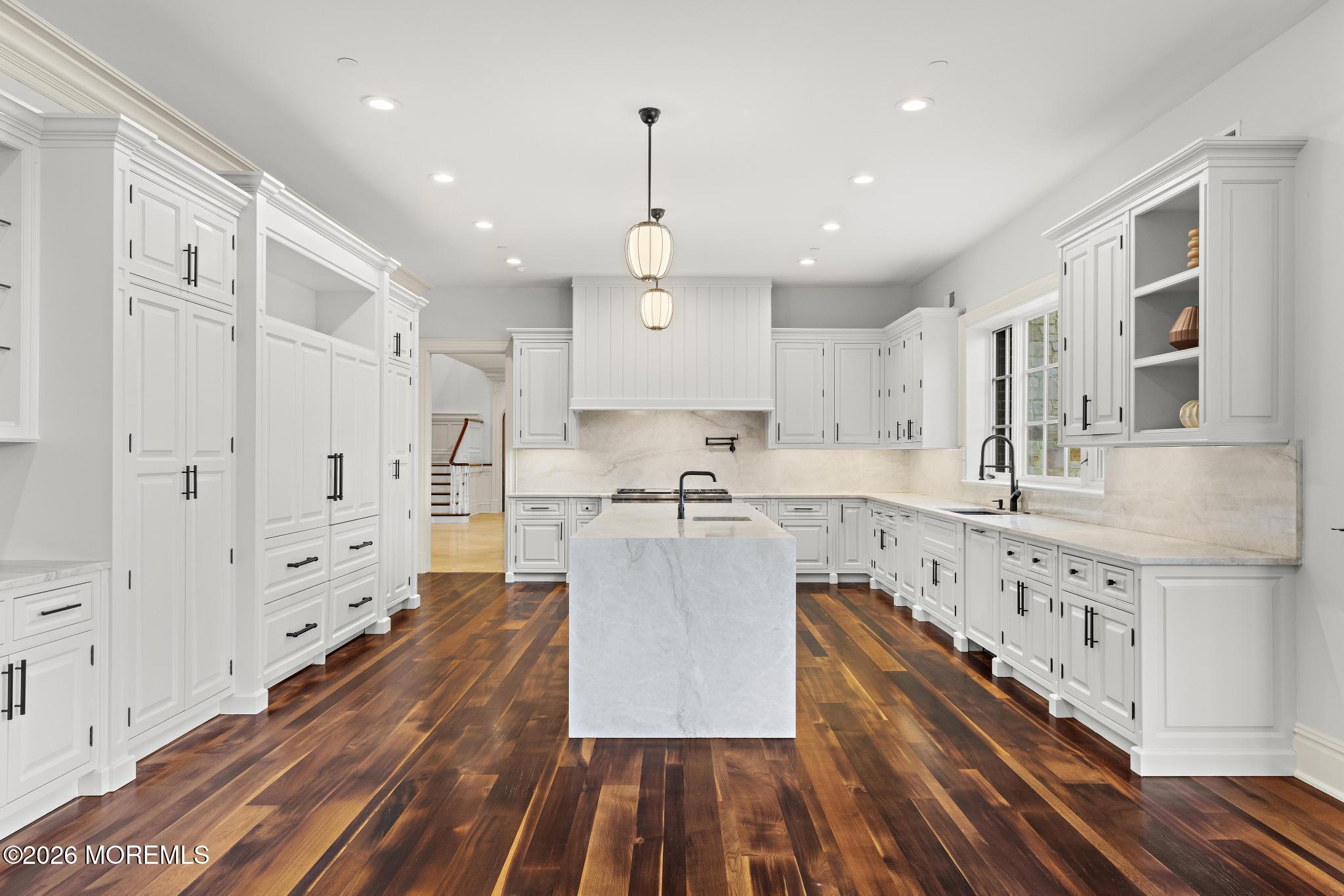 88 Montrose Road Colts Neck, NJ 07722 - Photo 21 of 73 a large kitchen with stainless steel appliances granite countertop a lot of counter space and wooden floors