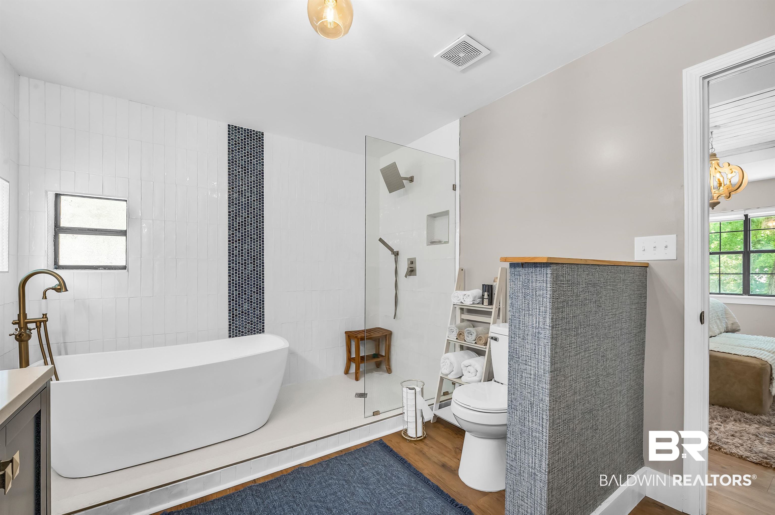 5215 Pine Road Orange Beach, AL 36561 - Photo 34 of 60 Ensuite bathroom featuring wood finished floors, a freestanding bath, and walk in shower