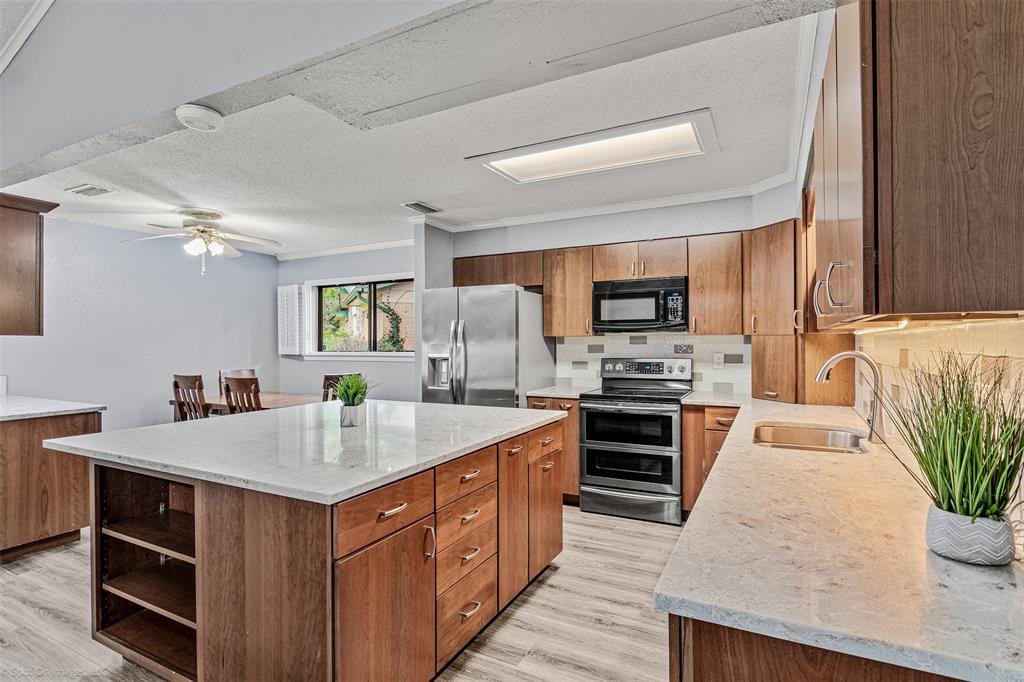 a kitchen with a sink stove and oven