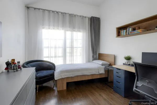 a bedroom with a bed and a chair