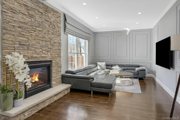 a living room with furniture a fireplace a flat screen tv and a fireplace