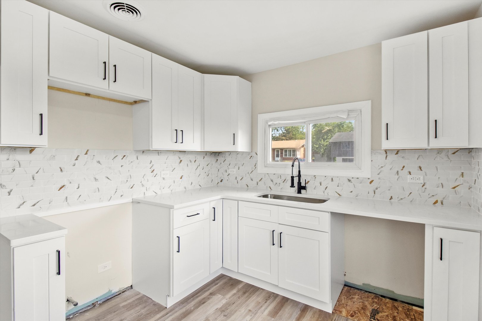 16460 Honore Avenue Markham, IL 60428 - Photo 9 of 38 a kitchen with white cabinets appliances a sink and a window
