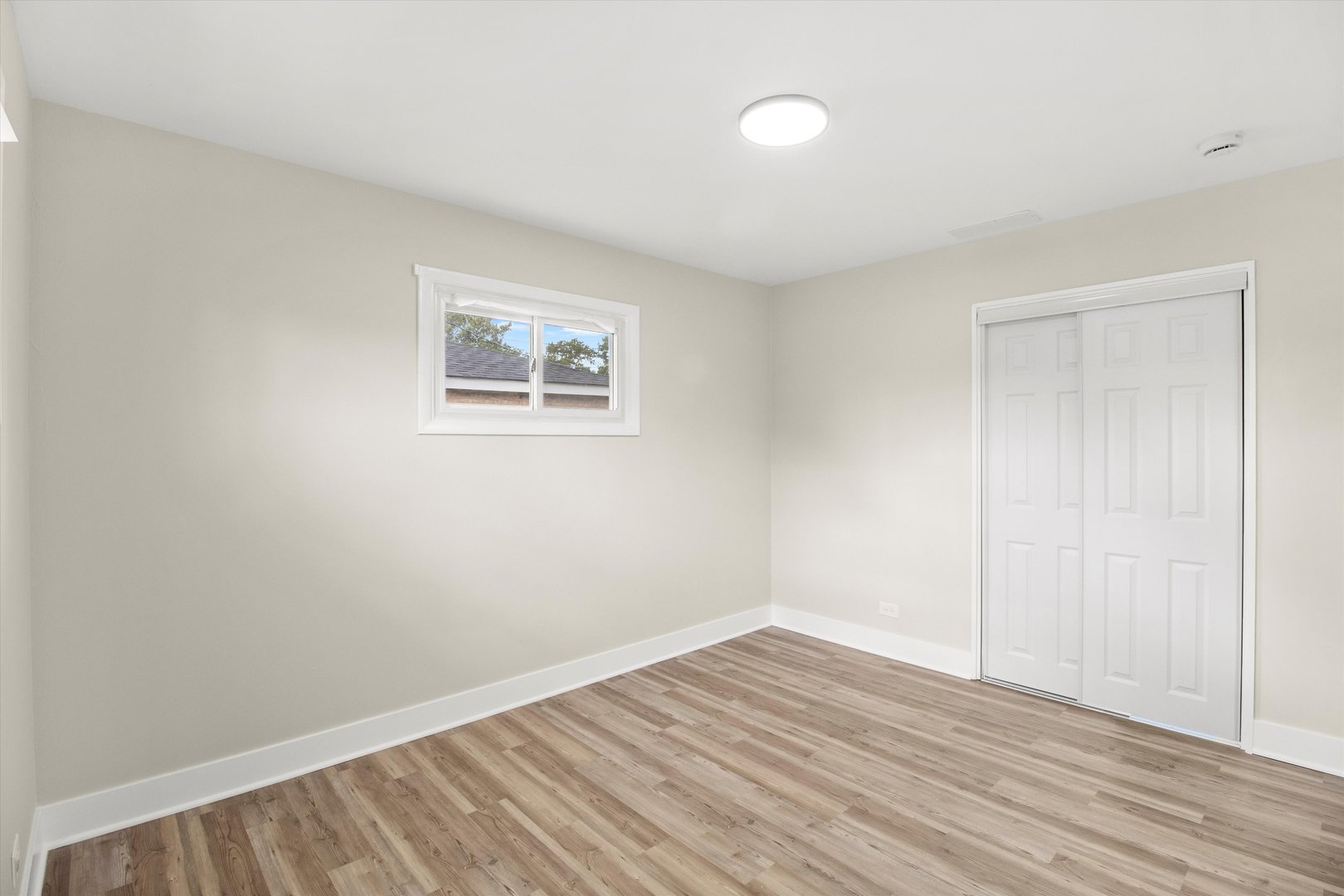 16460 Honore Avenue Markham, IL 60428 - Photo 14 of 38 a view of an empty room with wooden floor and a window