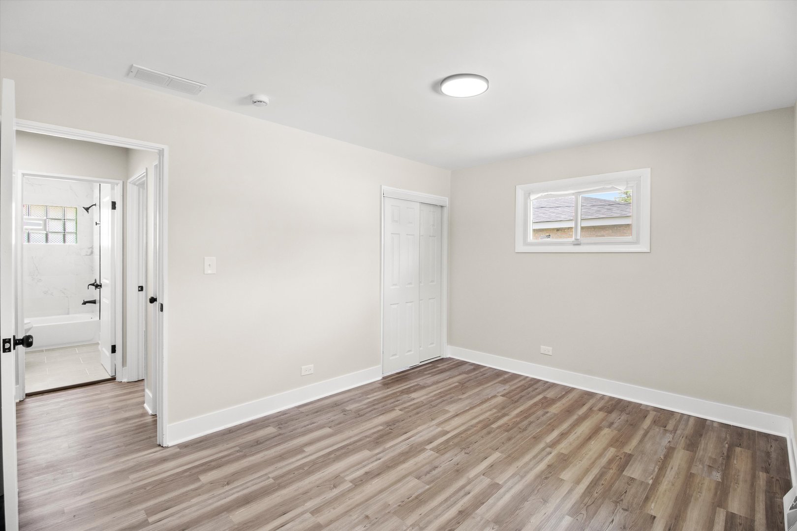 16460 Honore Avenue Markham, IL 60428 - Photo 20 of 38 an empty room with wooden floor and windows