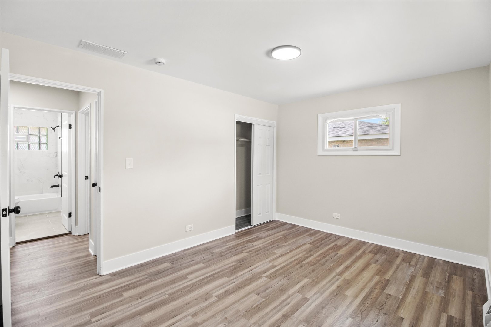 16460 Honore Avenue Markham, IL 60428 - Photo 21 of 38 an empty room with wooden floor and windows