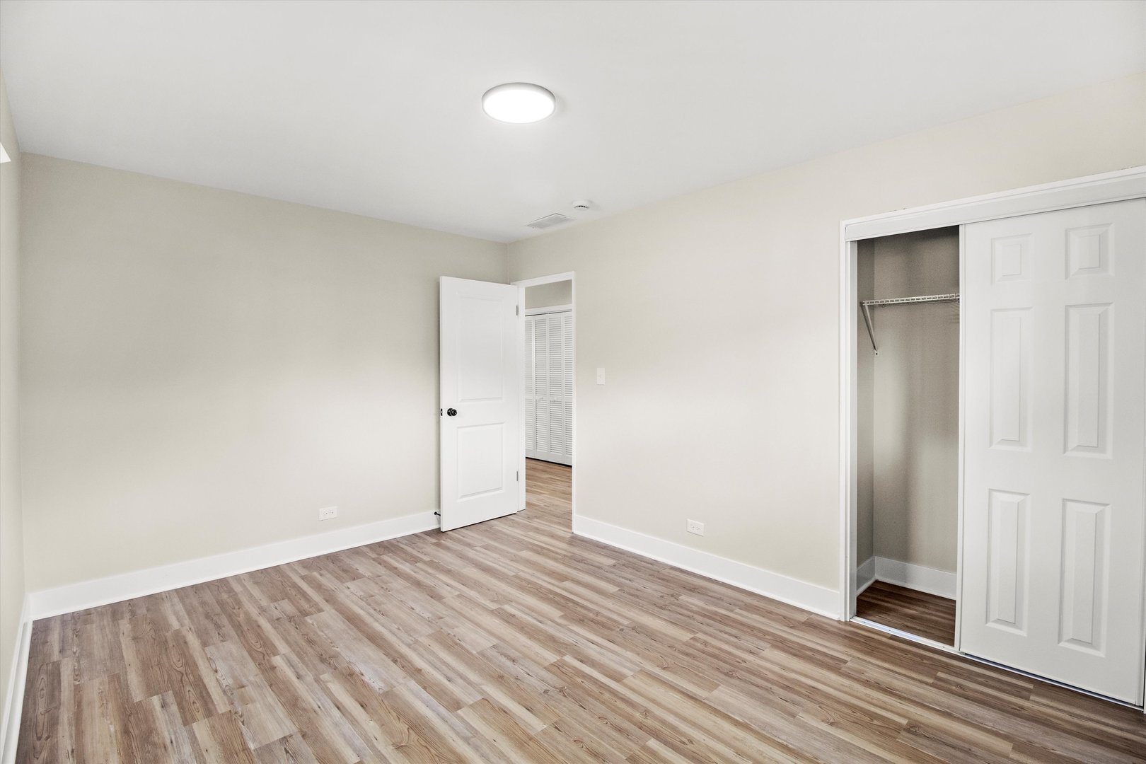 16460 Honore Avenue Markham, IL 60428 - Photo 23 of 38 an empty room with wooden floor and windows