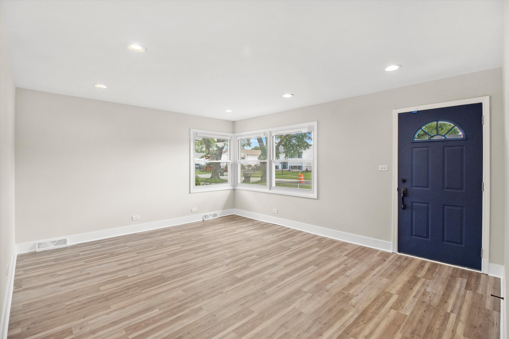 16460 Honore Avenue Markham, IL 60428 - Photo 3 of 38 a view of an empty room with wooden floor and a window