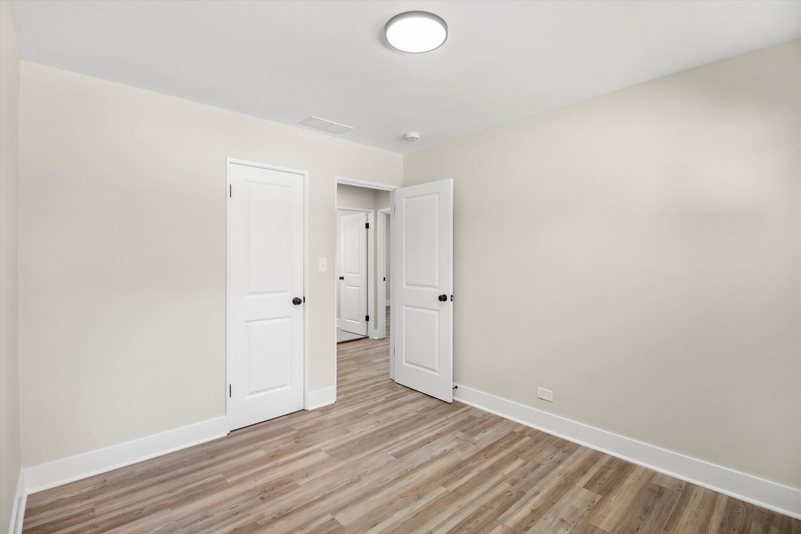 16460 Honore Avenue Markham, IL 60428 - Photo 29 of 38 a view of an empty room with wooden floor and a window