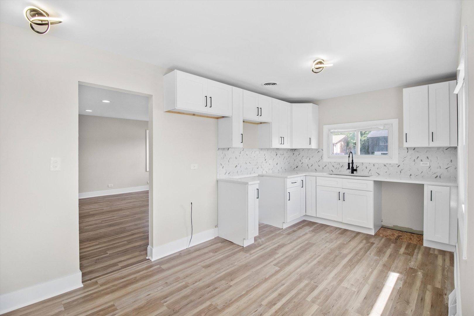 16460 Honore Avenue Markham, IL 60428 - Photo 8 of 38 a kitchen with wooden floors white cabinets appliances and a sink
