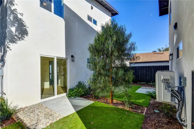 a house with a potted plant in front of door