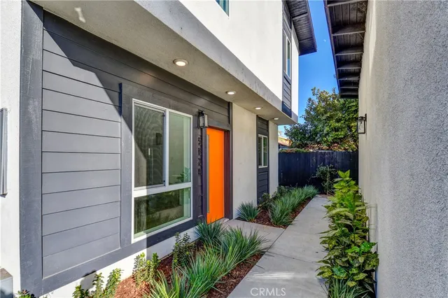 a view of a house with sitting area and potted plants