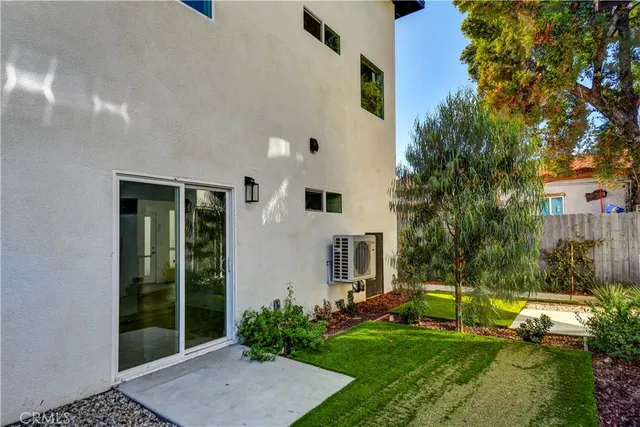 a kitchen with granite countertop wooden floors stainless steel appliances and window
