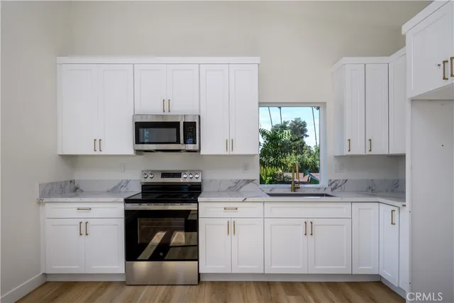 a bathroom with a granite countertop toilet and a sink
