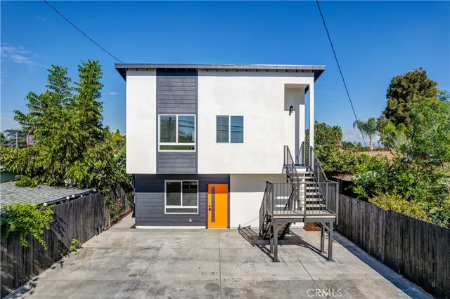 an aerial view of a residential houses with outdoor space