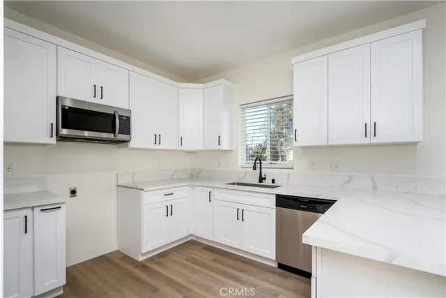a kitchen with a sink stove and microwave
