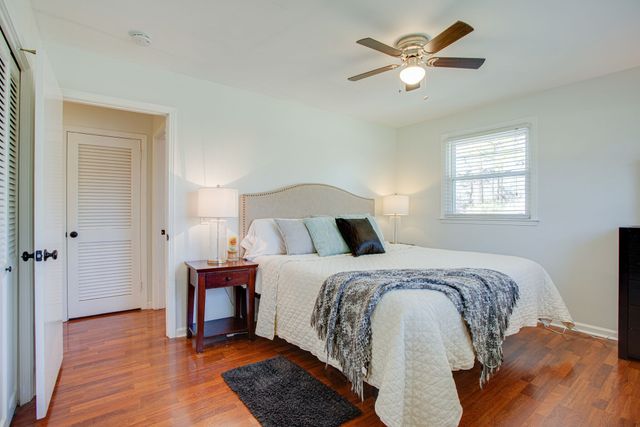 a bedroom with a bed and a ceiling fan