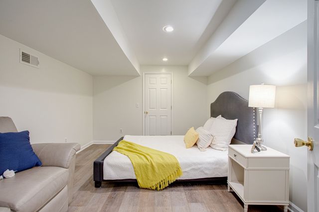 a bedroom with a bed and lamp