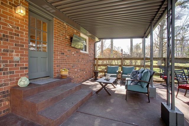 a backyard of a house with outdoor seating