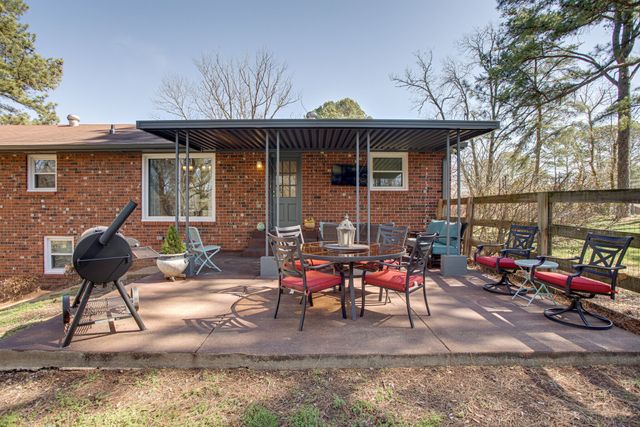 a patio with table and chairs