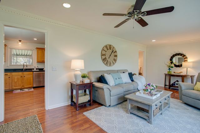 a living room with furniture and kitchen view