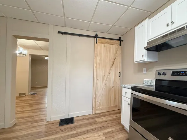 a kitchen with granite countertop a stove and a refrigerator