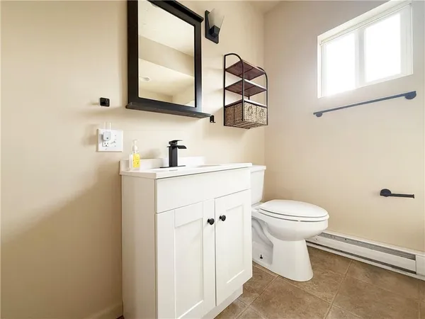 a bathroom with a toilet sink and mirror