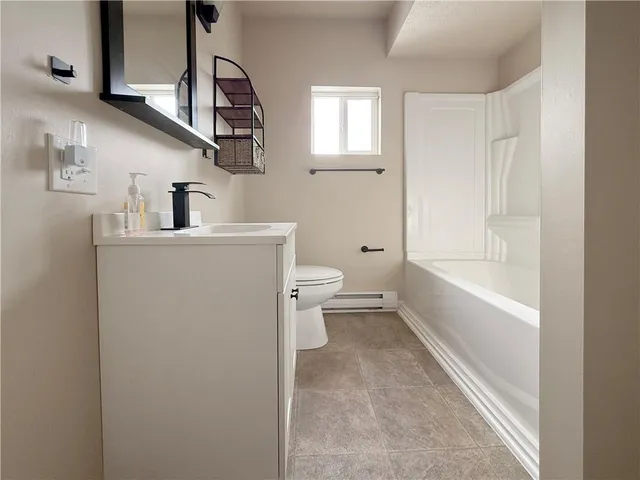 a bathroom with a sink a toilet and bathtub