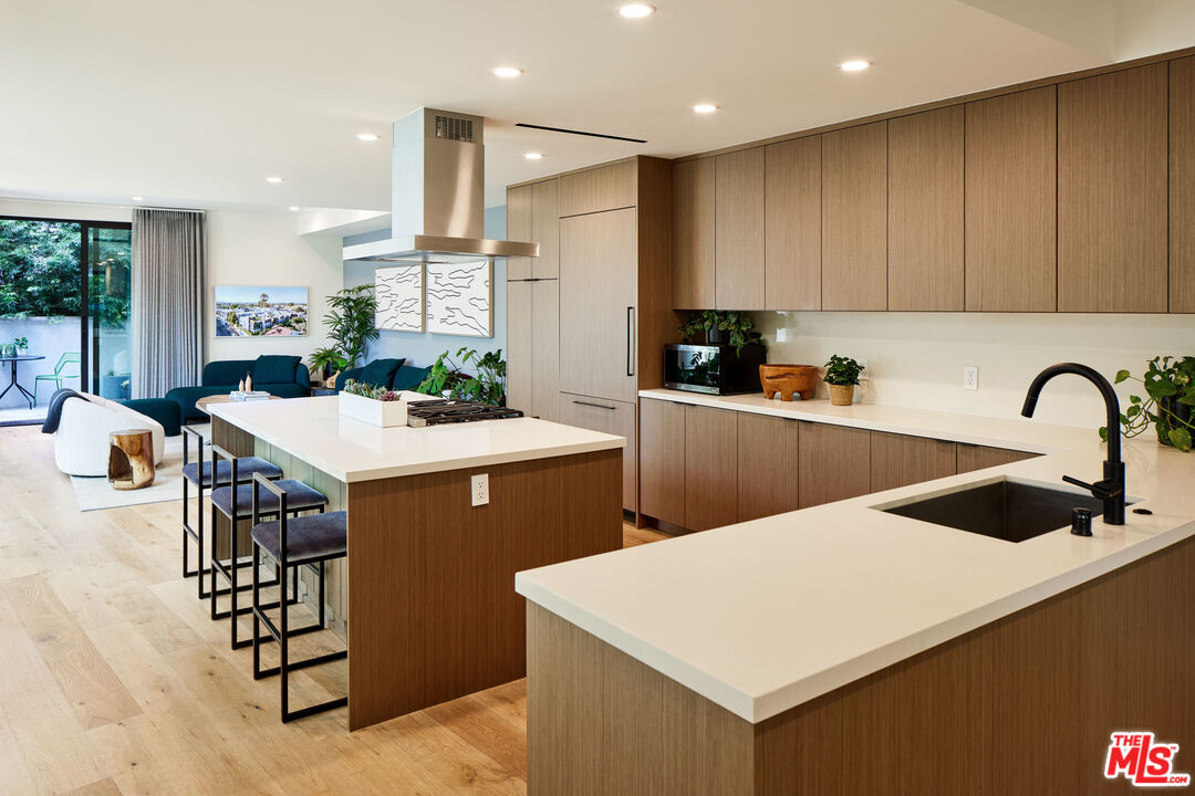 330 Rennie Avenue, Unit 1 Venice, CA 90291 - Photo 11 of 34 a kitchen with stainless steel appliances a sink a table and chairs
