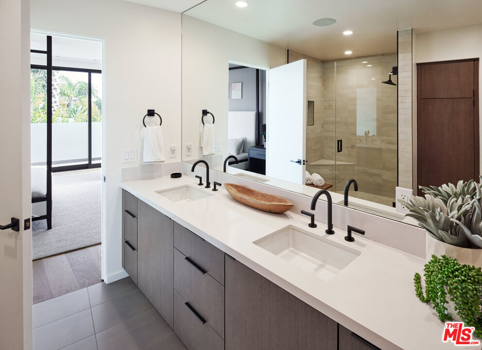330 Rennie Avenue, Unit 1 Venice, CA 90291 - Photo 14 of 34 a bathroom with a double vanity sink a mirror and a shower