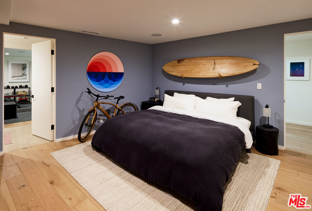 330 Rennie Avenue, Unit 1 Venice, CA 90291 - Photo 27 of 34 a bedroom with a bed and a chandelier