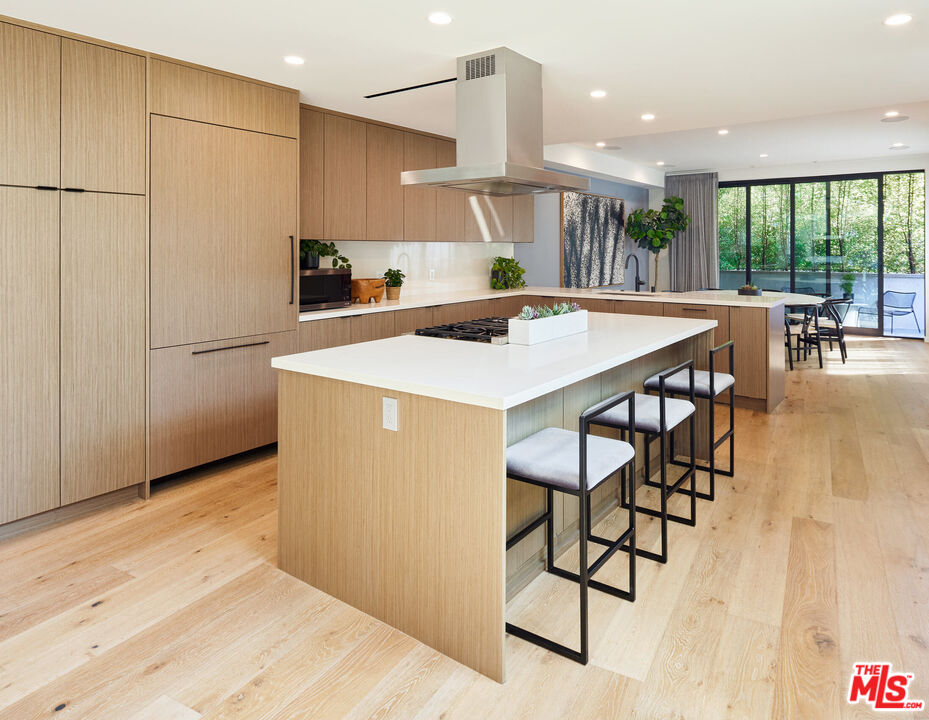 330 Rennie Avenue, Unit 1 Venice, CA 90291 - Photo 7 of 34 a kitchen with a table chairs refrigerator and wooden floor